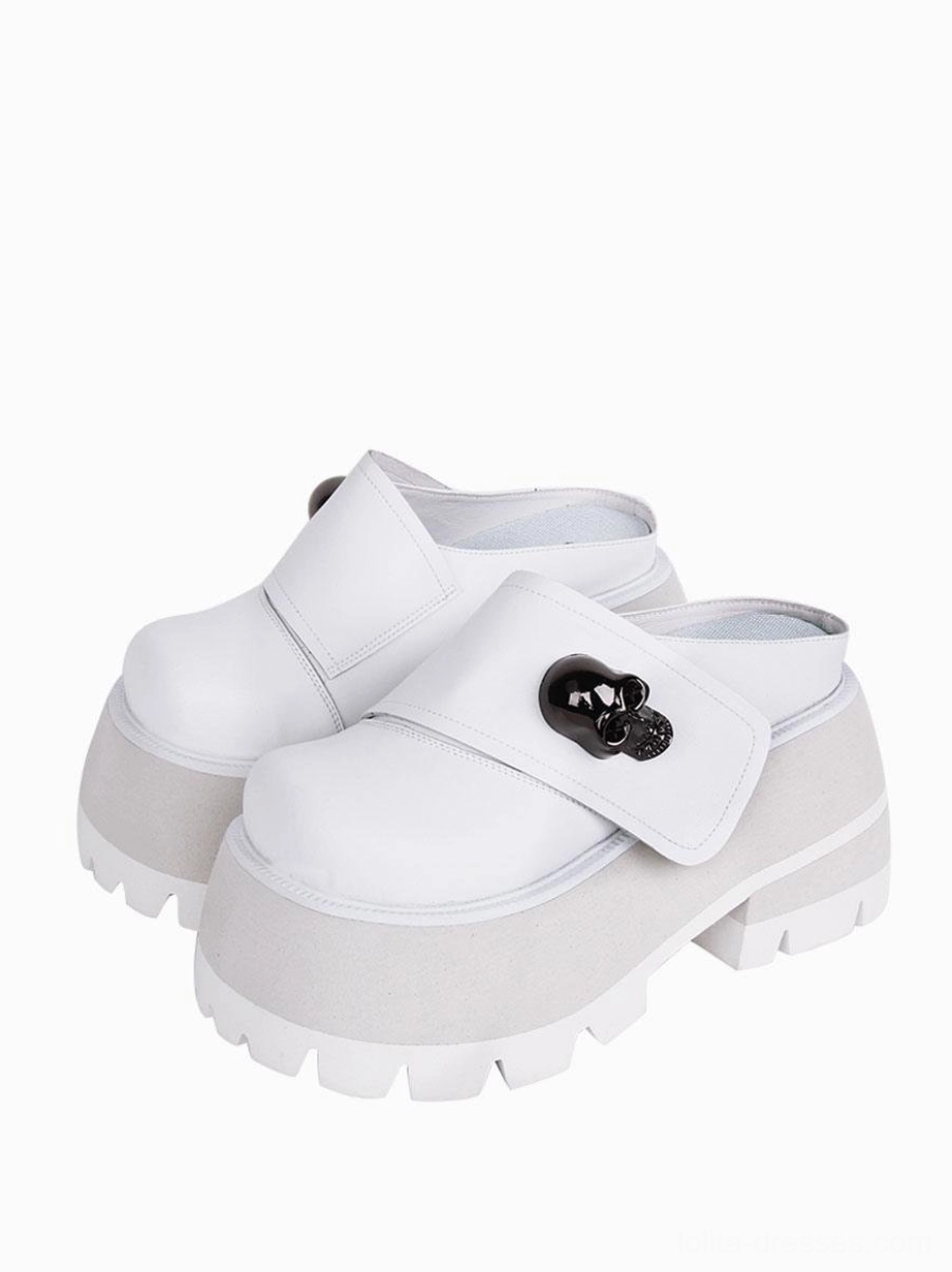 White Gothic Lolita platform mule sandals with skull buckle ornament front three-quarter view studio shot
