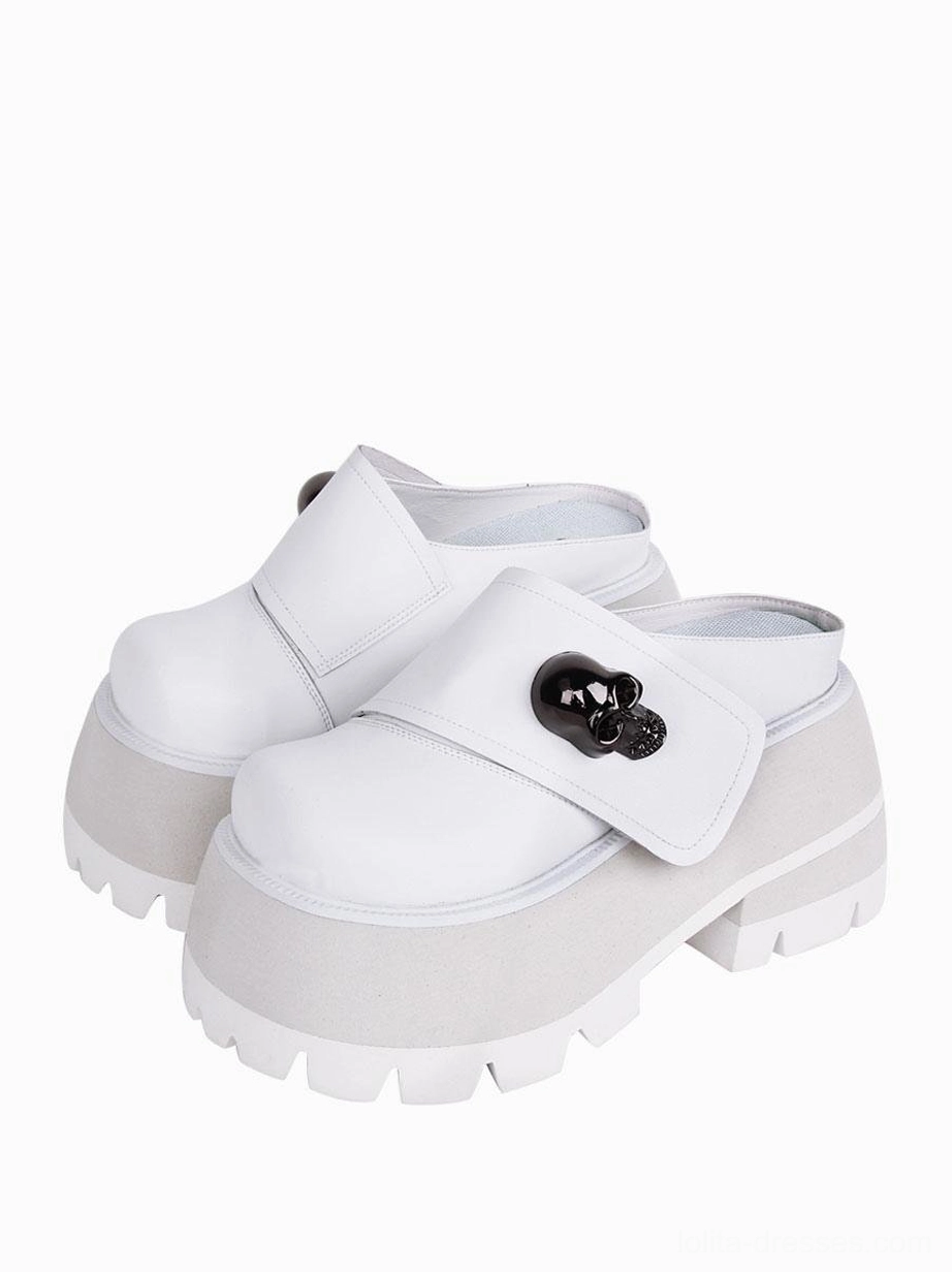 White PU leather platform mule loafers with black metal skull decoration chunky platform sole front angle