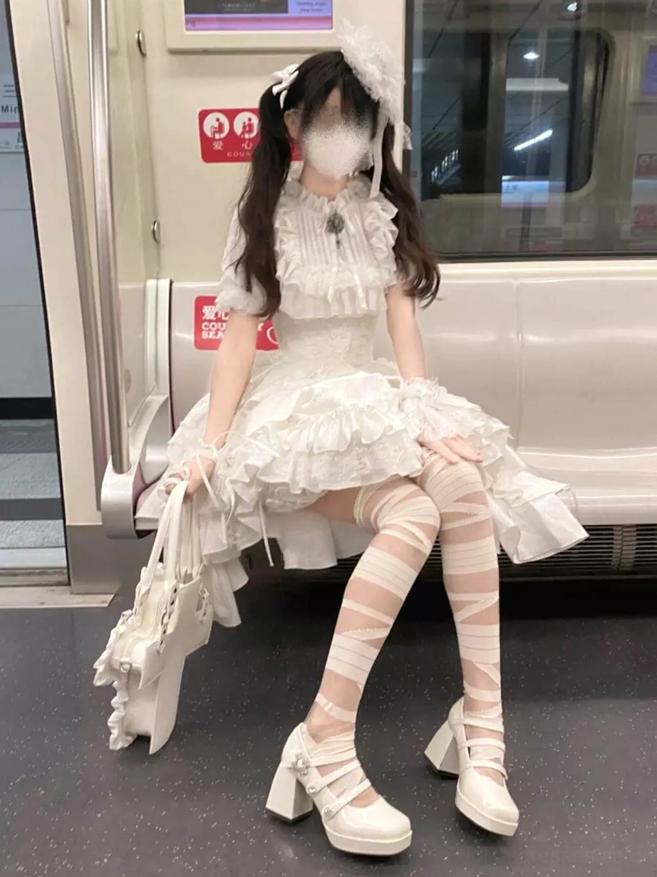 Gothic lolita white two-piece dress set with white lace-trimmed blouse and white tiered ruffled high-low skirt showcasing elegant lolita silhouette and jacquard pattern