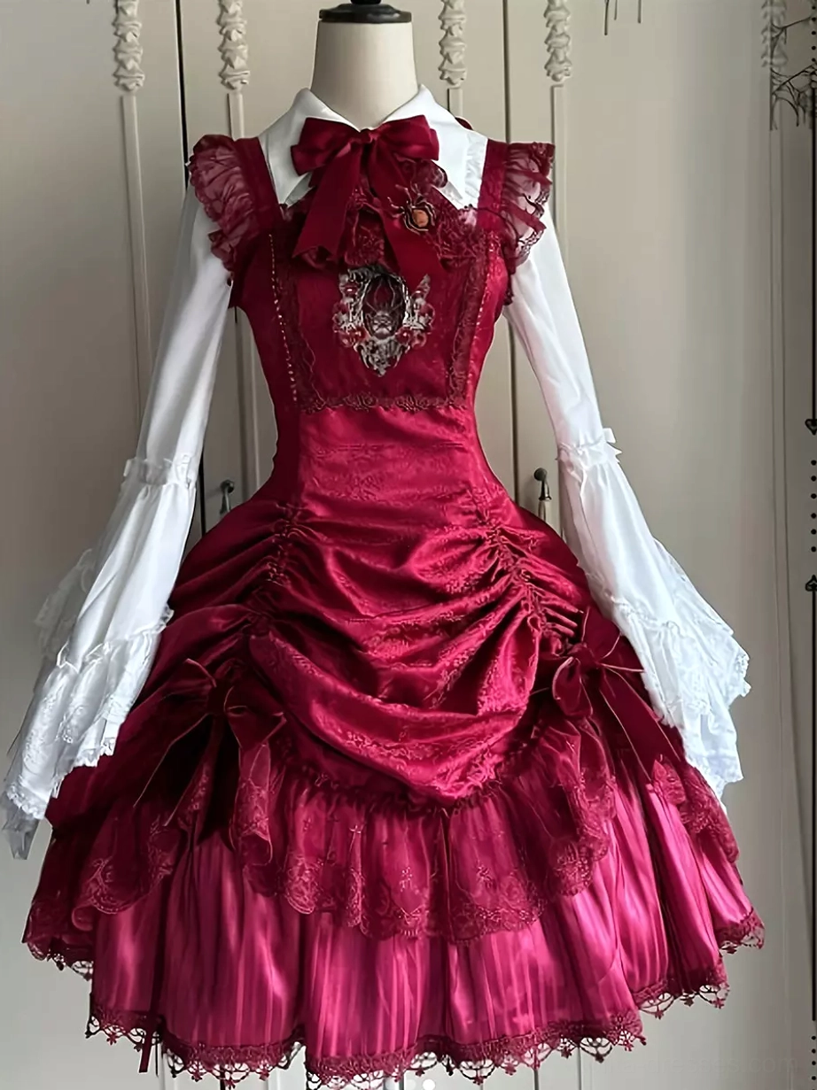 wine red gothic lolita pinafore dress styled with white long sleeve bell sleeve blouse and burgundy bow tie coordination