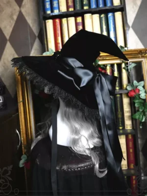 Black velvet gothic lolita witch hat with delicate lace brim trim and black satin bow, rear view on long grey wig mannequin display