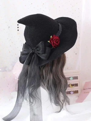 Gothic lolita witch hat with black sheer bow and red fabric rose, rear view on mannequin with starry pink backdrop, featuring long ribbon streamers and black bead tassel charm
