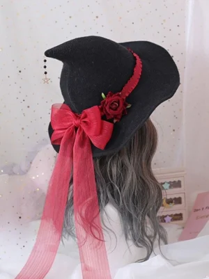 Gothic lolita witch hat with wine-red satin bow and long ribbons, red fabric rose embellishment, wine-red hat trim, rear view with star tassel charm on starry pink background