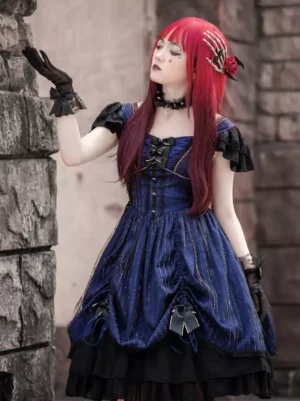 Gothic navy blue striped Lolita jumper dress with ruffled off-shoulder sleeves and black bow skirt decorations, front three-quarter view worn by red-haired model outdoor stone wall