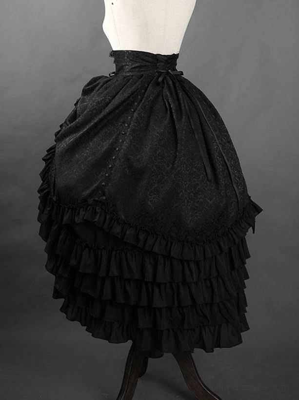 Back three-quarter view of black Gothic Ouji jacquard ruffled skirt showing lace-up construction, layered hem details, and textured jacquard fabric on mannequin