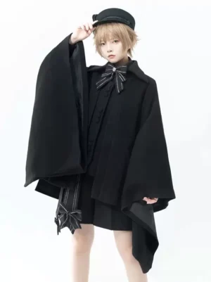 Black Gothic Ouji Lolita cloak three-quarter front angle displaying detachable handkerchief hem bow decoration and dramatic sleeve flare