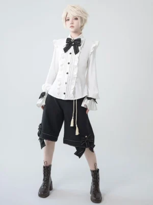 Gothic Ouji Lolita bloomers front view full outfit with ruffled white blouse black bow tie and decorative bows on black shorts studio photography