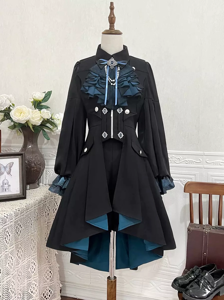 Hanging display of Gothic Ouji Lolita coat and shorts set showing ruffled collar detail, dark teal lining, asymmetric high-low hem, vintage aesthetic