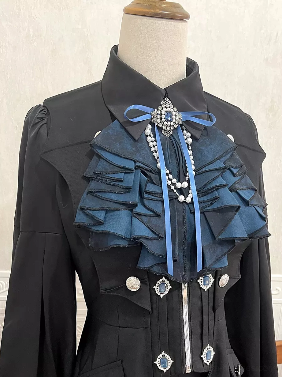 Close-up detail of Gothic Ouji Lolita cravat featuring ruffled edging, blue ribbon bow, pearl pendant, and metal brooch decorations