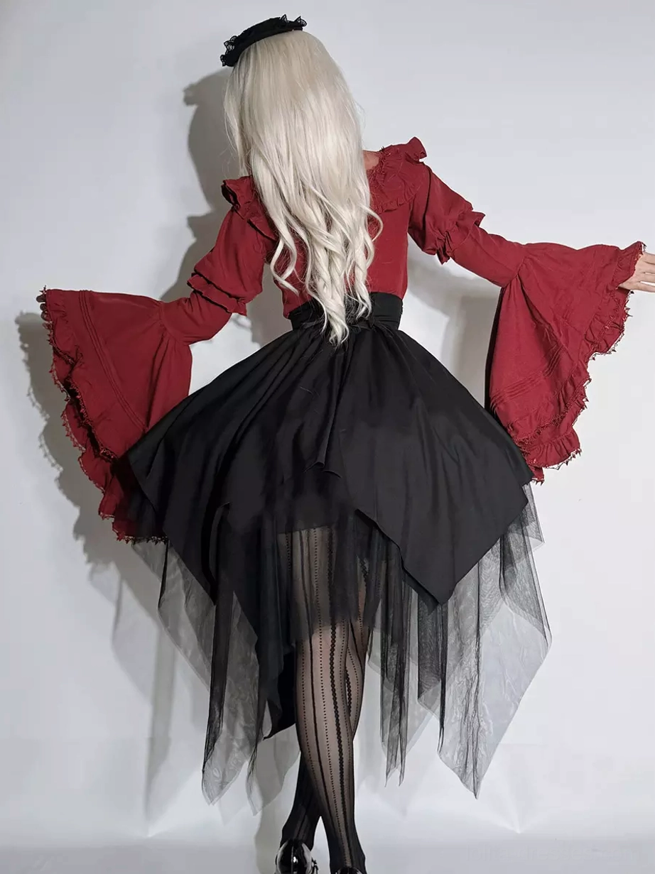 Back full-body view of Gothic Ouji Lolita ensemble showing long silver blonde hair wide red bell sleeves high-waist black tulle skirt and sheer tights layering