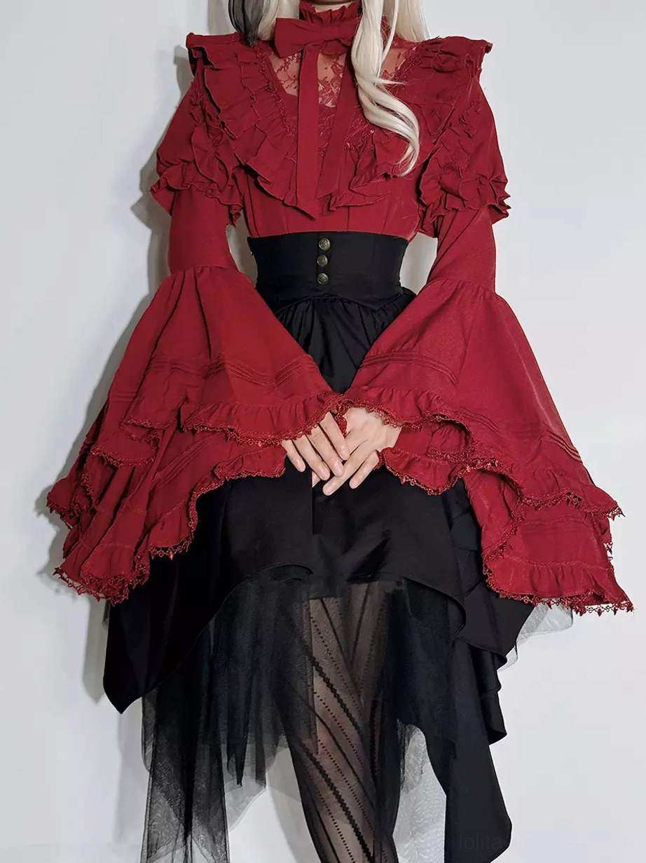 Gothic Ouji Lolita red ruffle blouse black asymmetrical tulle skirt set front view worn by model with blonde hair and folded hands showing dramatic bell sleeves and high-waist design