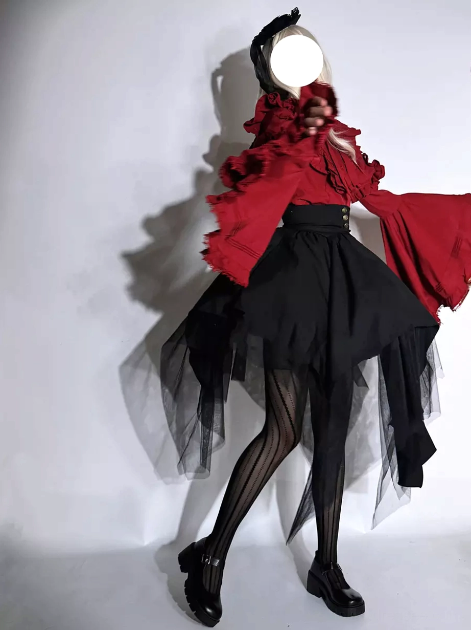 Side three-quarter view of Gothic Ouji Lolita two-piece set showing flounced red blouse black high-waist tulle skirt with black leather shoes and striped tights