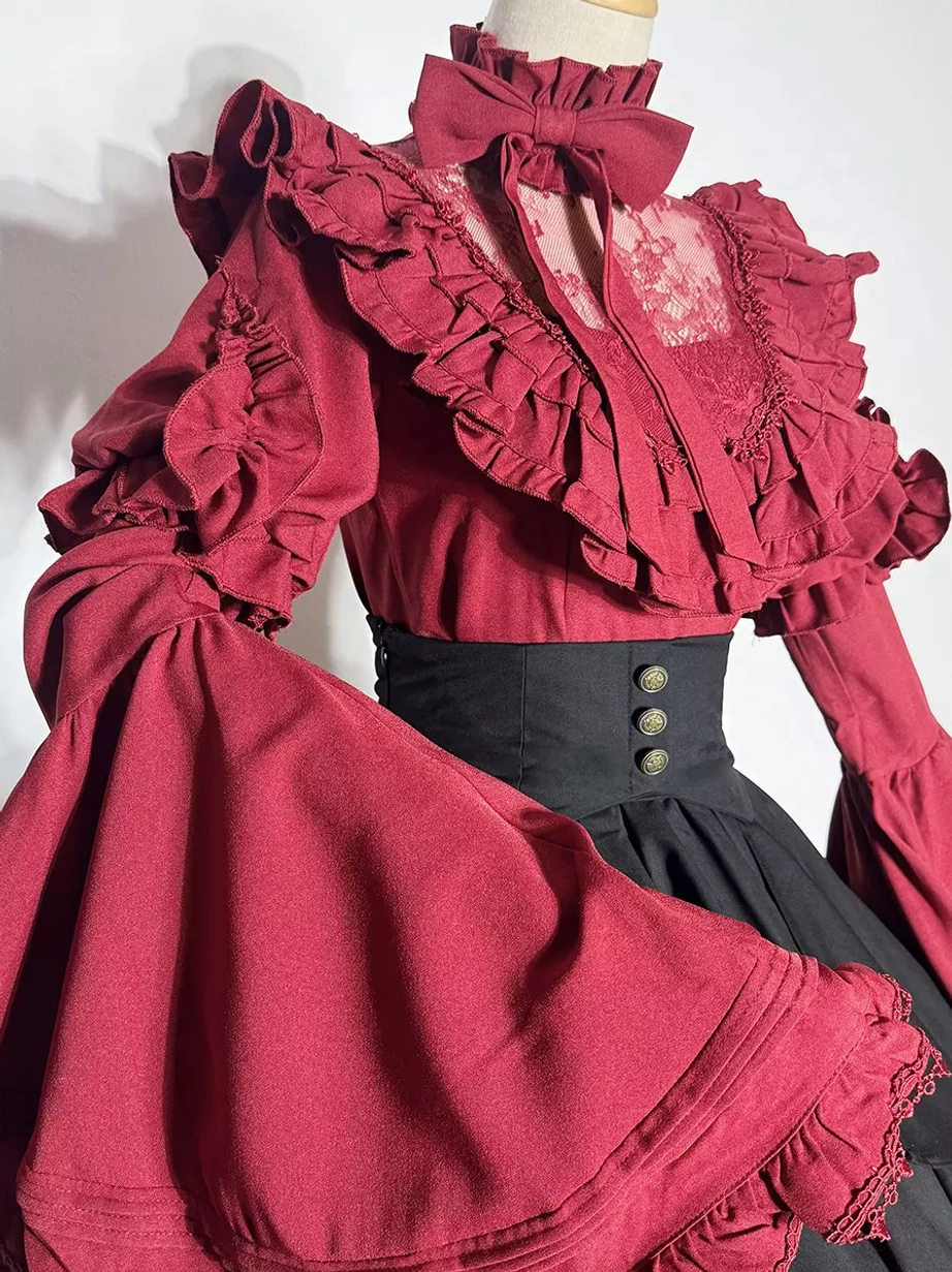 Close-up front view of Gothic Ouji Lolita blouse showing lace neck panel ruffled trim oversized bell sleeves and stand-collar construction details