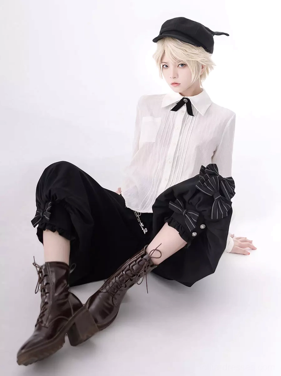 Gothic ouji outfit sitting position view with large side bow on cropped pants and formal lolita coordinate styling