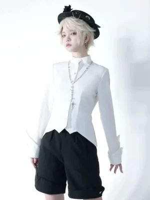 Gothic Ouji Lolita white stand collar blouse front full-body view with flared cuffs and pointed hemline, worn with black tailored shorts and cross pendant necklace by blonde lolita model in black top hat