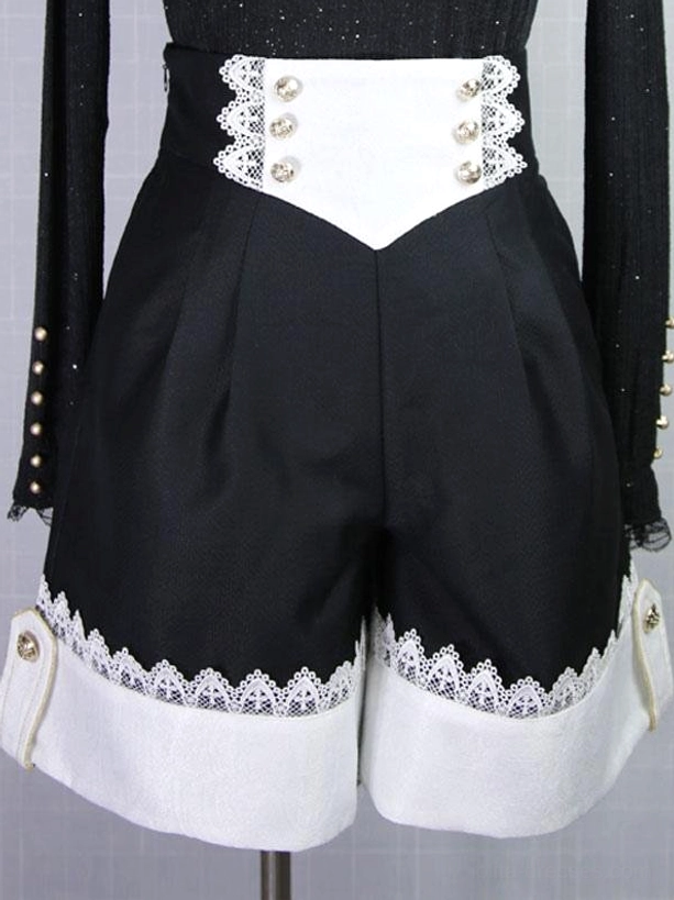 Close-up detail of Gothic Ouji high-waisted pleated shorts with lace-trimmed cuffs and pearl-buttoned waistband showing Ouji silhouette construction