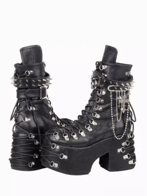 Punk gothic platform boots side three-quarter angle showing spiked ankle strap hanging chain pendants and lace-up eyelets with chunky wedge sole