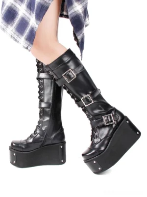 Gothic platform boots side angle view worn with plaid skirt showing high wedge platform multiple metal buckles and laced upper lolita fashion styling