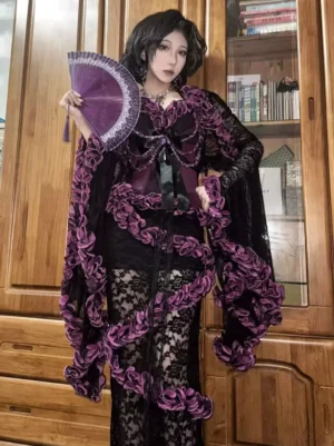 Gothic purple ruffle lace three-piece lolita outfit full front view with bell sleeve shrug and mermaid skirt worn with purple folding fan on wooden background