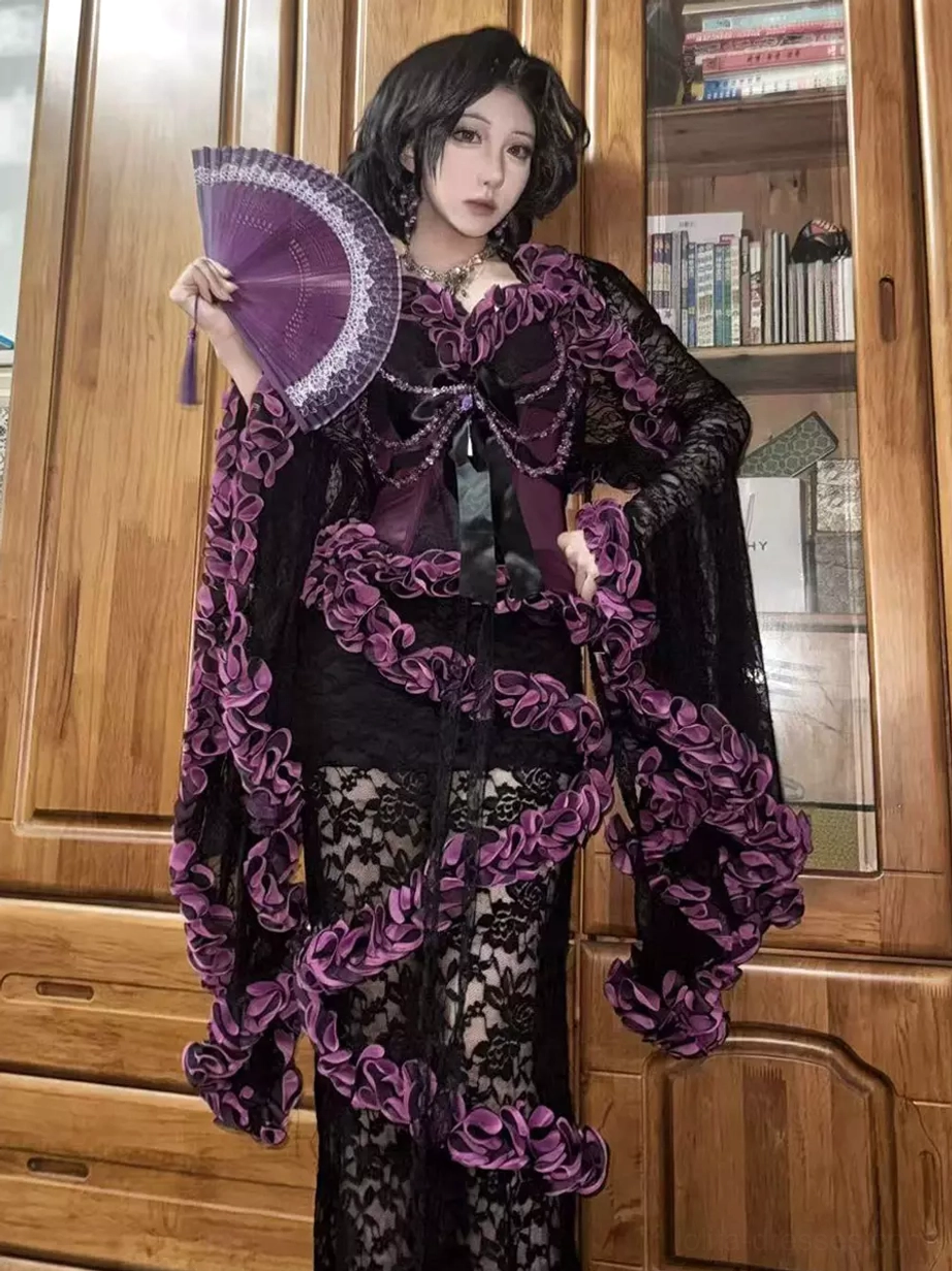 Gothic purple ruffle lace three-piece lolita outfit full front view with bell sleeve shrug and mermaid skirt worn with purple folding fan on wooden background