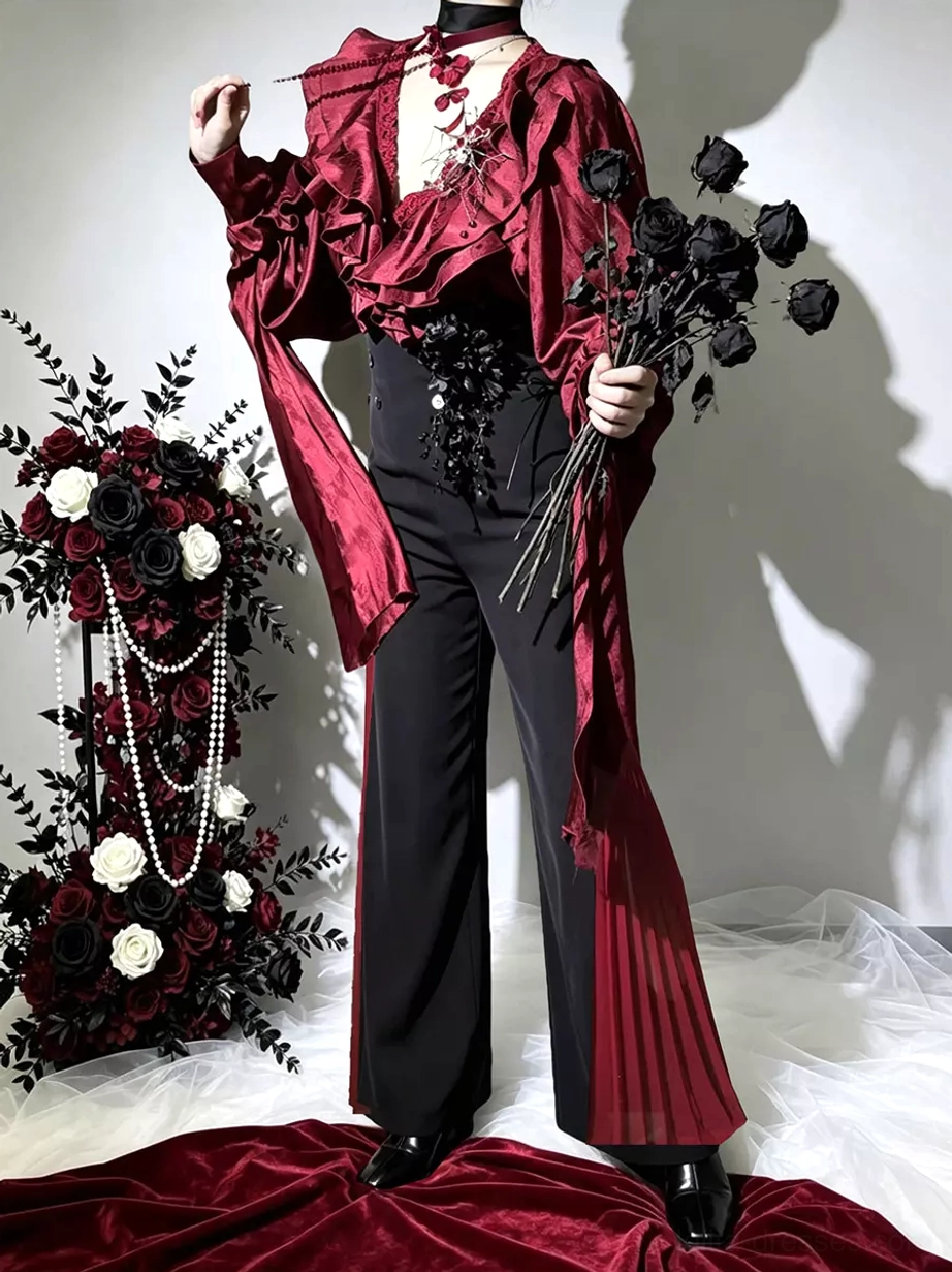 Gothic vampire lolita outfit with deep V-neck ruffle collar burgundy blouse, corset-style black waist decoration, and flowing wide-leg pants, accessorized with black rose bouquet and pearl-adorned dark floral studio decor