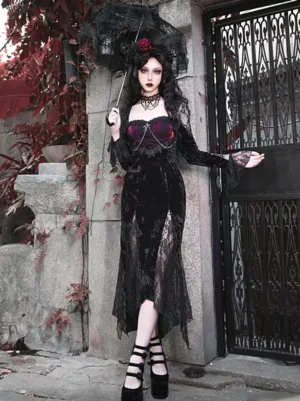 Gothic velvet fishtail Lolita dress full-body front view with wine red and black color, lace-up corset back, long flared sleeves, sheer lace thigh slit, worn with flower hair accessory at vintage outdoor gate