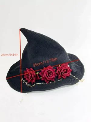 Flat lay top-down view of gothic witch hat lolita headpiece showing size measurement marks, wine red artificial roses, metal star chain decorations, and black woven fabric construction details