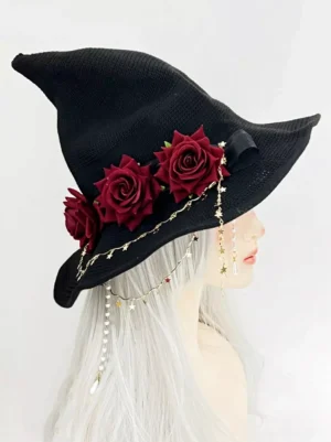 Gothic pointed witch hat lolita headpiece worn on mannequin with silver long hair, displaying right side view with black woven fabric, wine red artificial roses, and star pearl chain decorations