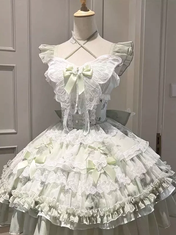 Green fairy lolita JSK dress on mannequin displaying cross halter neckline ruffled shoulders layered lace skirt