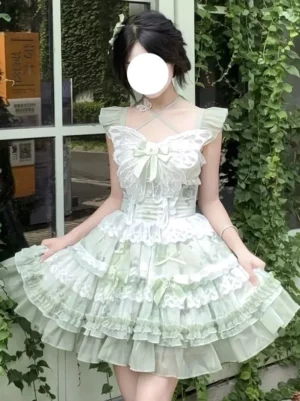 Green fairy lolita JSK dress front three-quarter view with lace ruffle tiers and butterfly bow detail