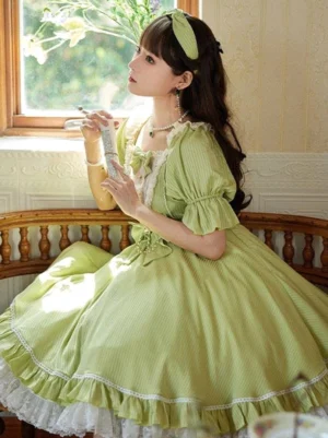 Green short sleeve sweet lolita dress side profile showing fitted waist bow and layered ruffled skirt hem