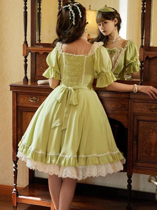 Back view of green sweet lolita dress displaying square back neckline and back waist sash bow