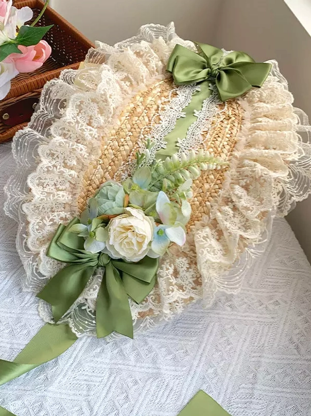 Tiered ruffled skirt layers and hem detail of green sweet lolita dress showing multiple ruffle construction, volume-creating layering, and floral embroidery on skirt portions