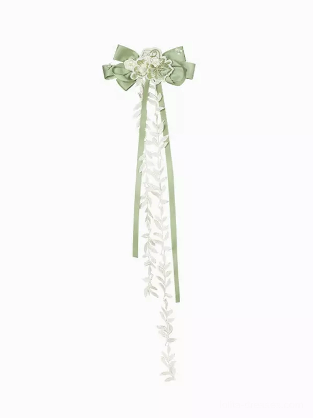 Waist sash bow and bodice detail of green sweet lolita dress showcasing decorative ribbon placement, floral embroidery pattern, and fitted waist construction for authentic silhouette