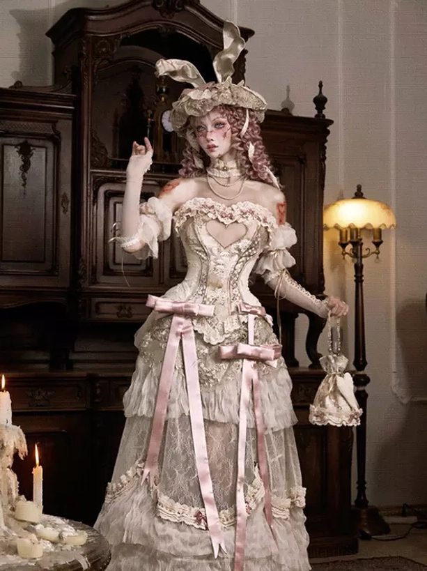 Bustier ivory lolita dress with heart cutout corset, tiered skirt and mini lace purse accessory, modeled with bunny ear hat