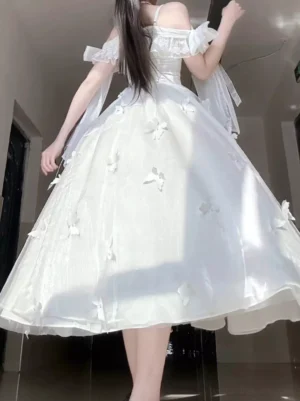 White off-shoulder Lolita wedding dress back view showing voluminous tulle ball skirt with 3D butterfly decorations and delicate tulle sashes