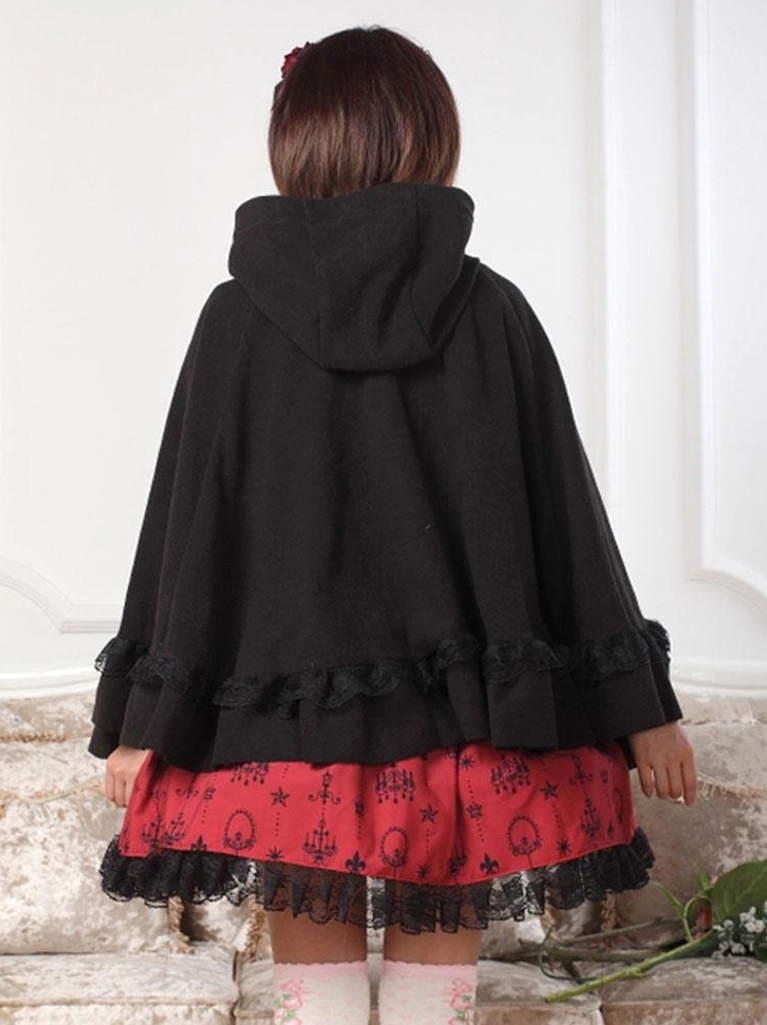 Back view of black hooded lolita cape coat showing fixed hood and ruffled bottom trim with white thigh-high stockings