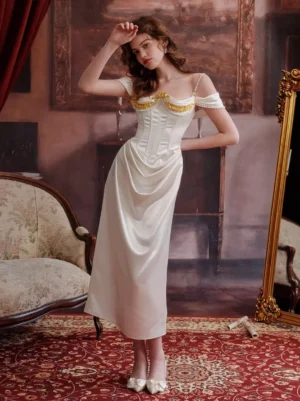Off-white satin fairy lolita dress with gold embroidery bust, pearl shoulder straps, corset waist, three-quarter front angle