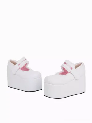 Pair of ivory lolita platform wedge heel shoes with thick sole and pink interior lining, side profile three-quarter view featuring velcro strap fastening