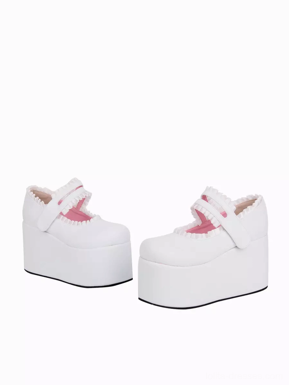 Pair of ivory lolita platform wedge heel shoes with thick sole and pink interior lining, side profile three-quarter view featuring velcro strap fastening