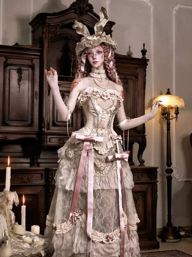 Bustier lolita skirt set with corset top, pink satin sashes and ruffled lace design, modeled with bunny ear hat showing complete ensemble