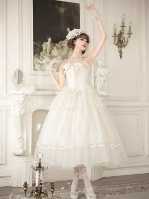 Short ivory lolita slip dress with sheer tulle hem and bow bust detail, paired with fishnet stockings and modeled in elegant palace room interior