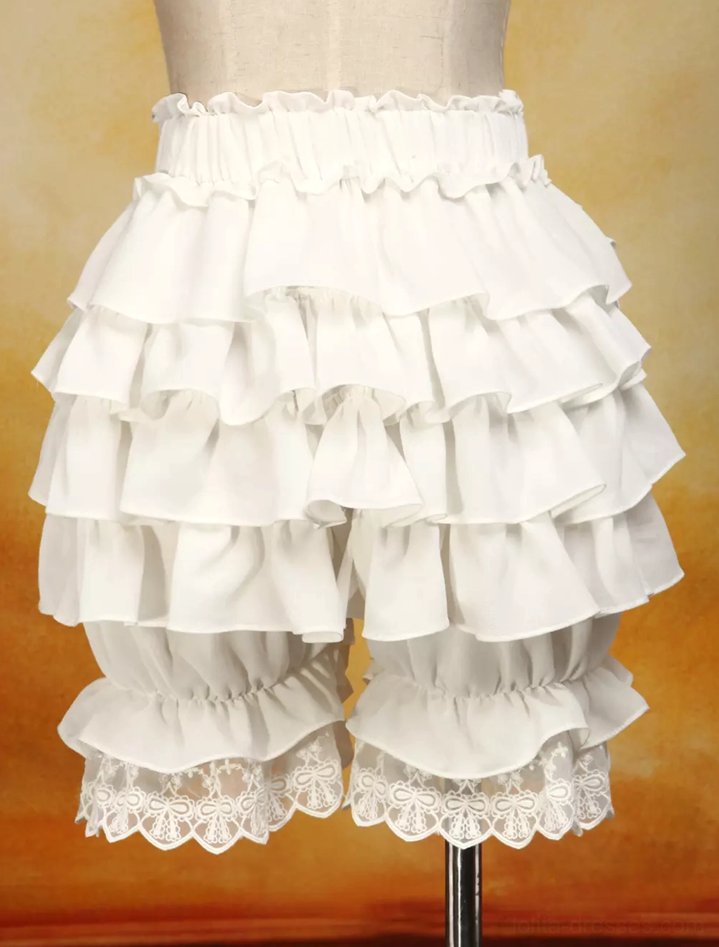 Rear back view of ivory bloomers showing bilateral layered ruffles, elastic high waist construction, and embroidered lace leg cuffs details