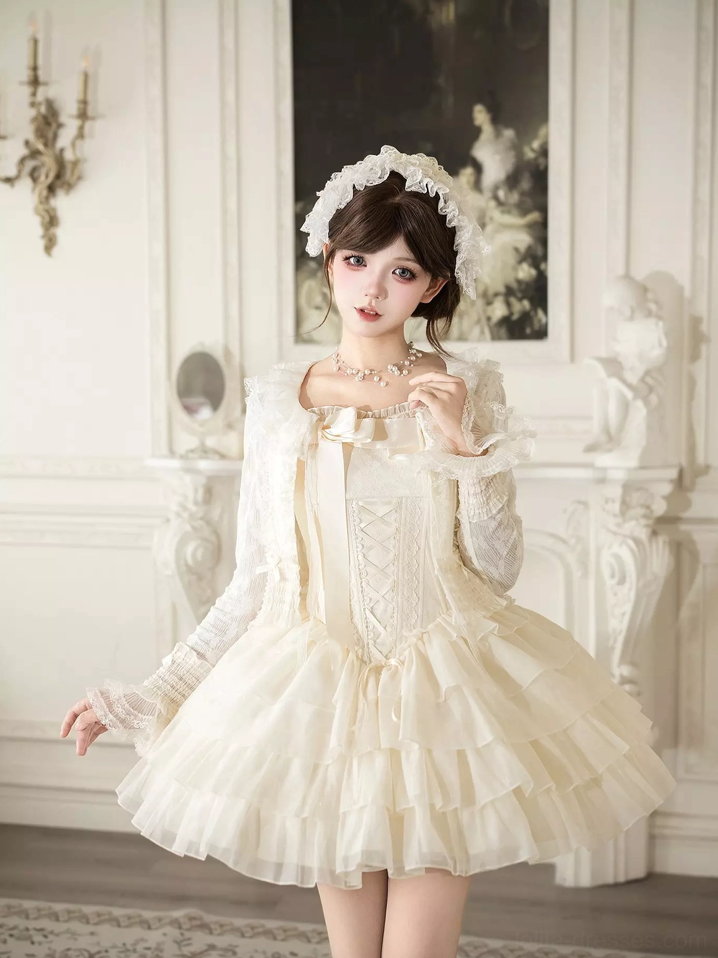 Ivory corset Lolita mini dress styled with matching lace sleeves shawl, front half-side view showing lace-up bodice tiered tulle skirt and hair accessory in European vintage room
