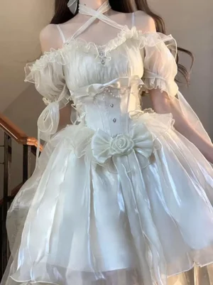 Close-up of ivory lolita dress bodice showing cross halter straps, rhinestone decoration, and structured corset design