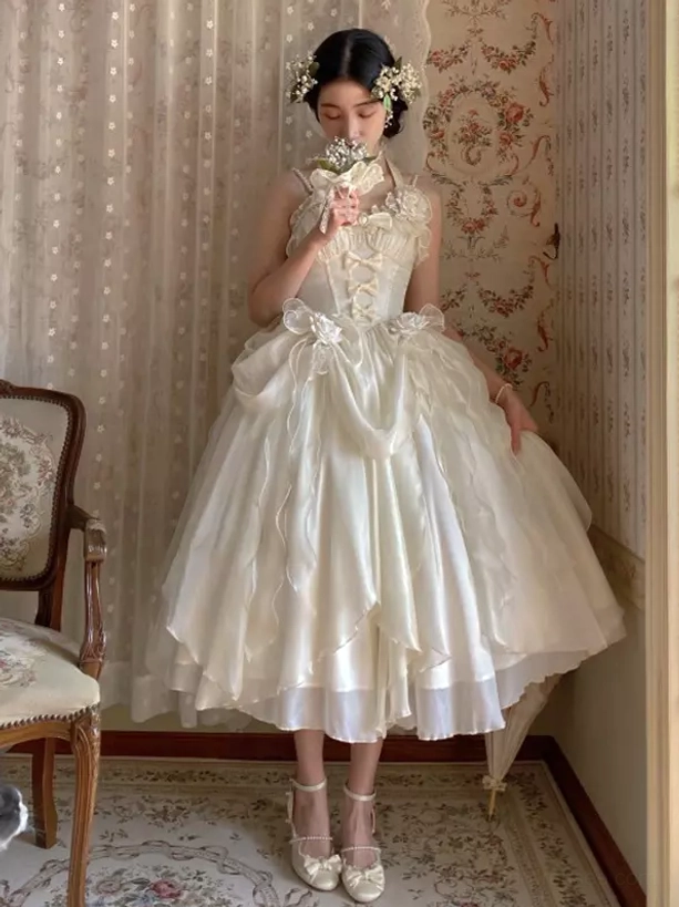 Ivory midi sleeveless lolita dress front full-body view halter neckline 3D waist flower embellishment ruffled skirt vintage room setting