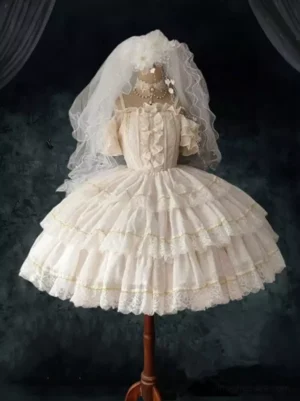Ivory sweet Lolita JSK dress with off-shoulder ruffled sleeves and multi-layered lace-trimmed skirt, featuring gold-tone accents and delicate embellishments on dress form
