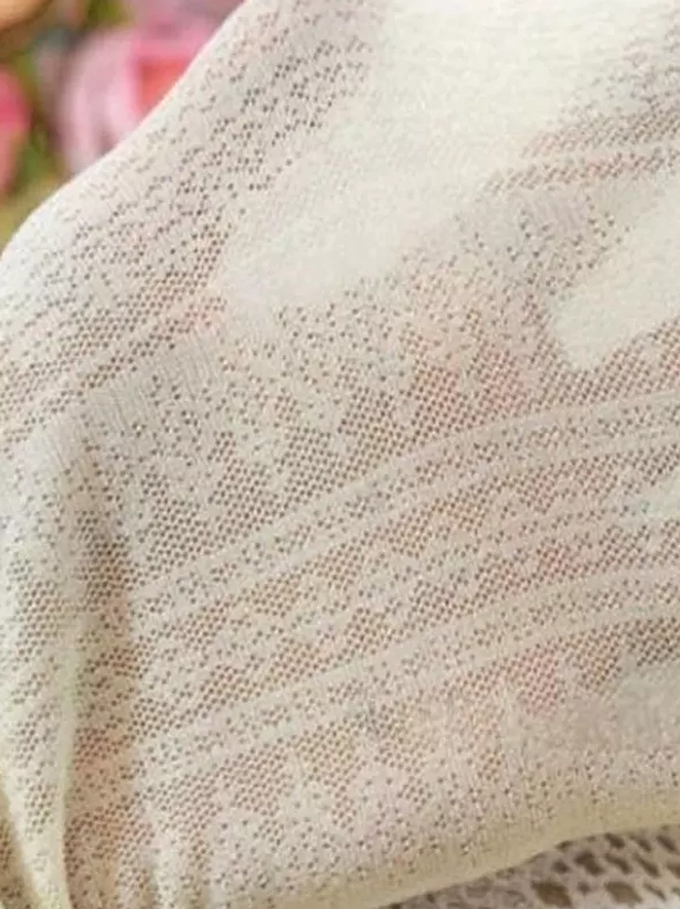 jacquard lace lolita tights fabric flat lay showing intricate hollow floral knit texture cream color luxury hosiery detail