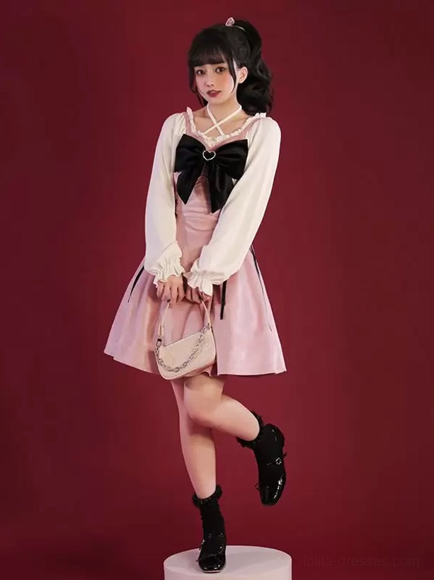 Two-tone Jirai Kei gothic lolita dress with white long puff sleeves, black chest bow, and color-block pink skirt design, three-quarter front view on model
