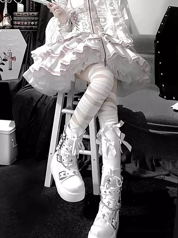 Knee-high bandage lolita socks with decorative bow details, side view of lower-body showing white wrapped design and gothic styling